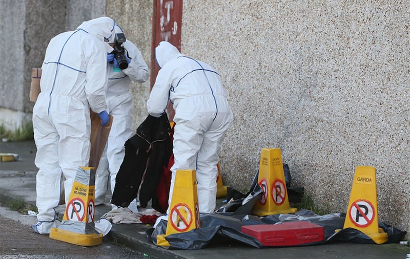&nbsp;Garda&iacute; remove items from the scene. Picture by Brian Lawless/ Press Association.