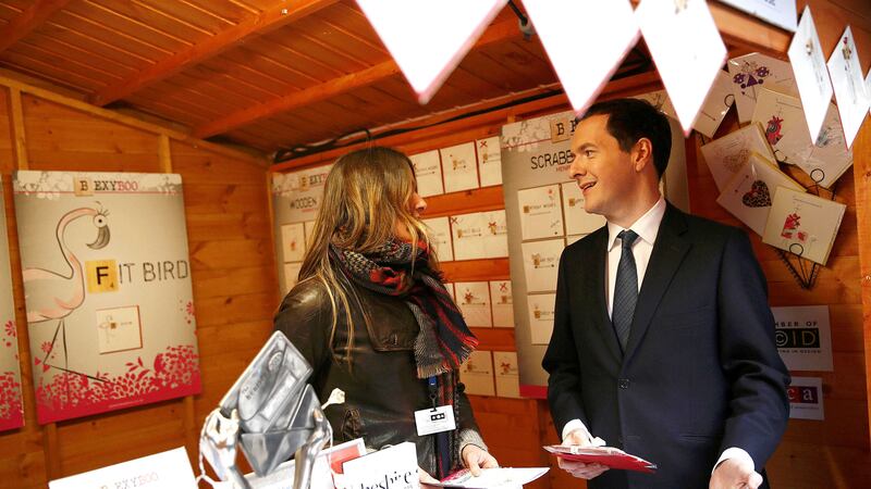 Chancellor of the Exchequer George Osborne talks with a stall holder during a tour of Small Business Saturday Christmas Fair at the Treasury in London. Picture by Stefan Wermuth, PA Wire&nbsp;