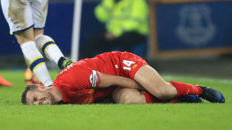 Liverpool captain Jordan Henderson is left in agony on the Goodison Park pitch after Ross Barkley's tackle on him during Monday's Merseyside derby <br />Picture by PA&nbsp;