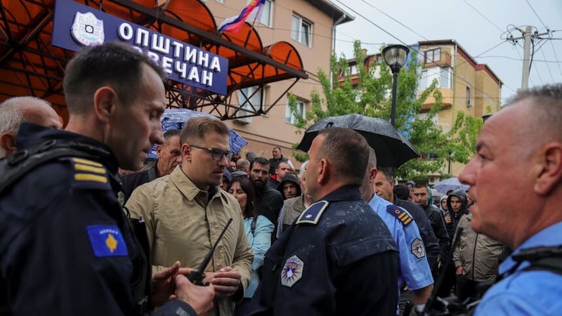 Aleksandar Arsenijevic, a local politician, talks to police officers in the town of Zvecan, Kosovo as ethnic Serbs clashed with police (Bojan Slavkovic/AP/PA)