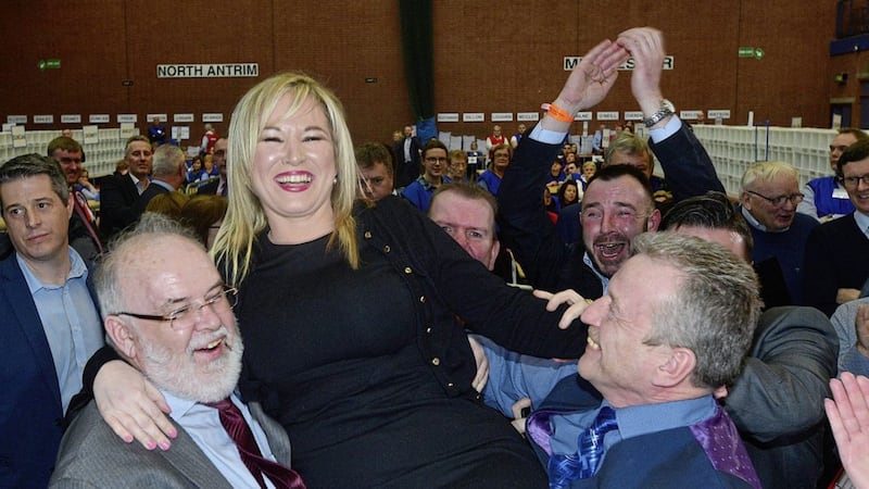 Michelle O&#39;Neill is held aloft by party colleagues Ian Milne and Francie Molly 