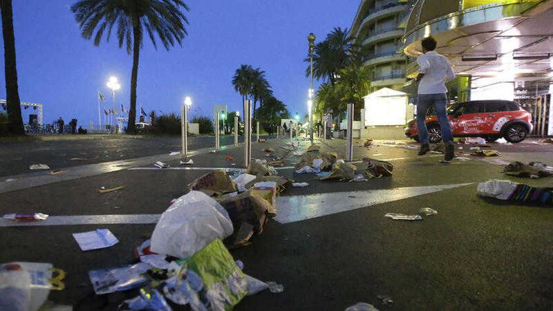 A man runs near the scene of the attack in Nice. Picture by AP Photo/Luca Bruno 
