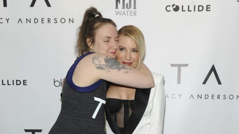 Lena Dunham hugs trainer to the stars Tracy Anderson at the opening party of her New York studio (Diane Bondareff/Invision for Tracy Anderson/AP Images)