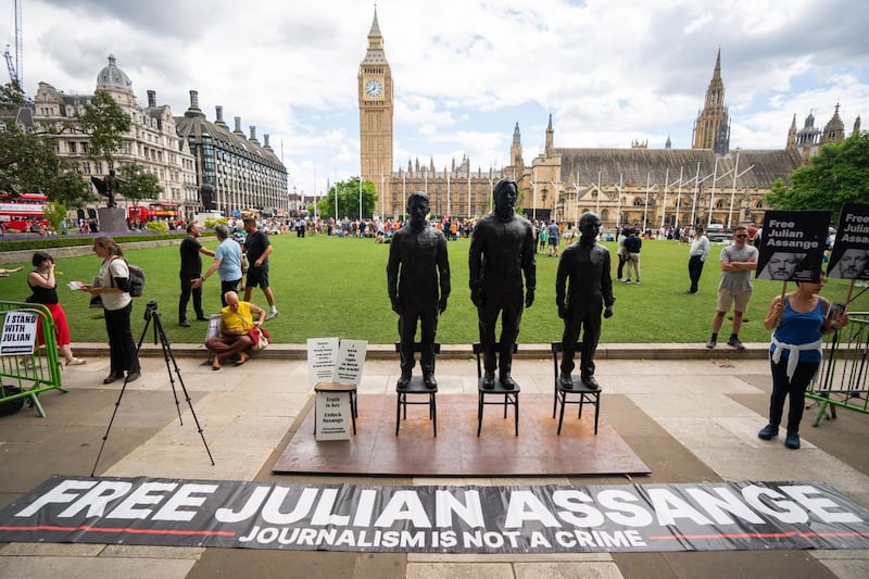 A sculpture called Anything To Say, which features life-sized bronze figures of whistleblowers (left-right) Edward Snowden, Julian Assange and Chelsea Manning, each standing on a chair, is unveiled at Parliament Square