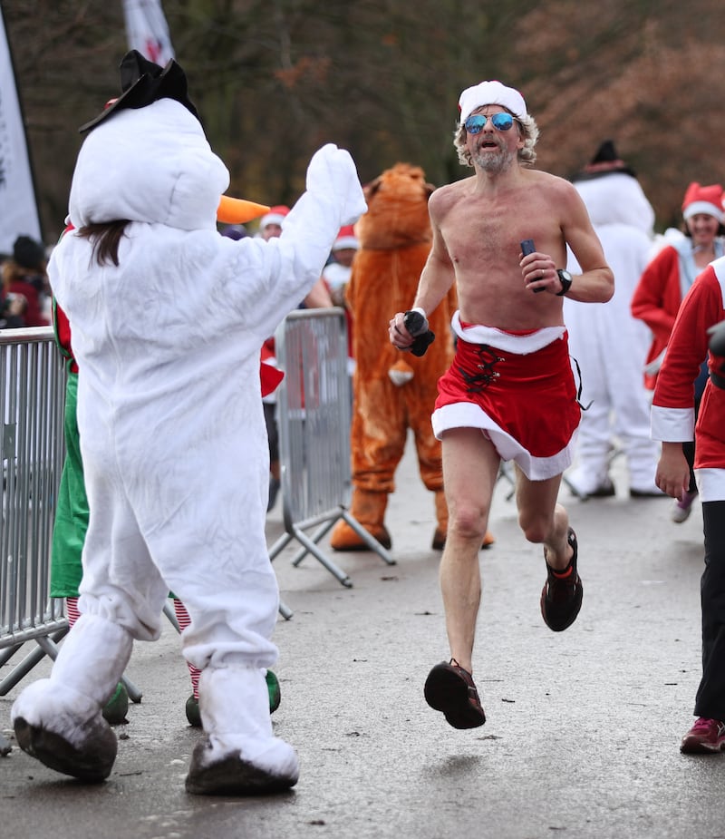 Participants taking part in the London Santa Run in Victoria Park, east London