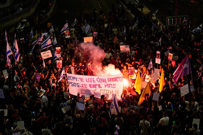 Israeli demonstrators block a road in Tel Aviv (Ariel Schalit/AP)