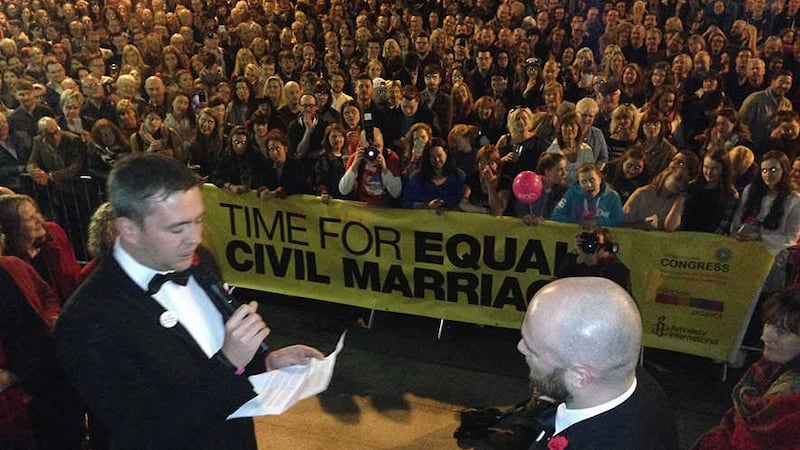 Malachai O&rsquo;Hara (left) and Michael McCartan exchange wedding vows before a crowd of hundreds in Belfast. Photograph: Amnesty International