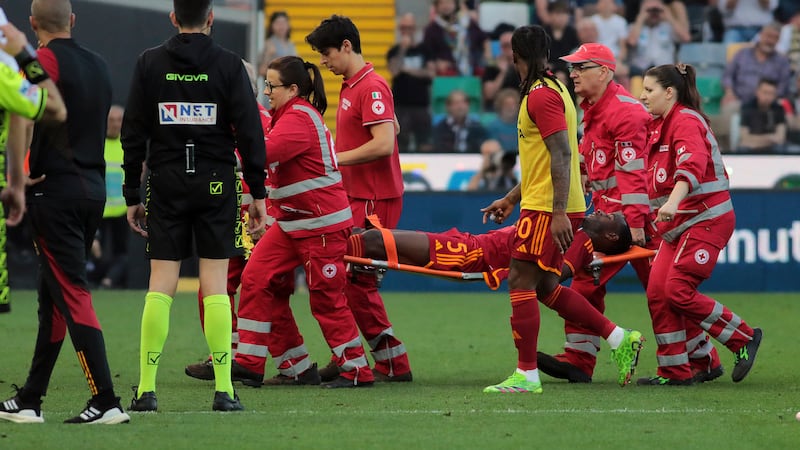 Roma’s Evan Ndicka is carried from the pitch on a stretcher