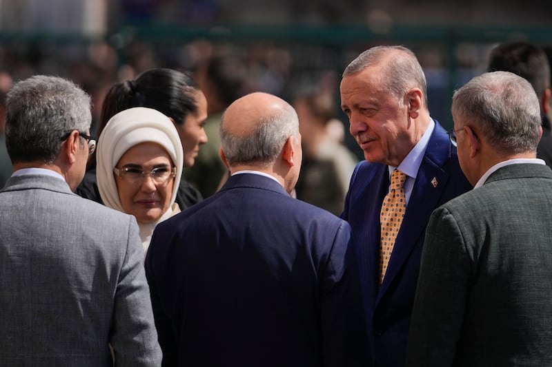 President Recep Tayyip Erdogan, right, arrives to vote to a polling station in Istanbul (AP Photo/Khalil Hamra)