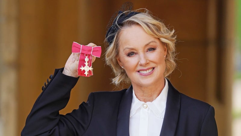 The actress, who has played the ambitious Sally Webster in the soap since 1986, received her medal for services to drama from the Princess Royal.