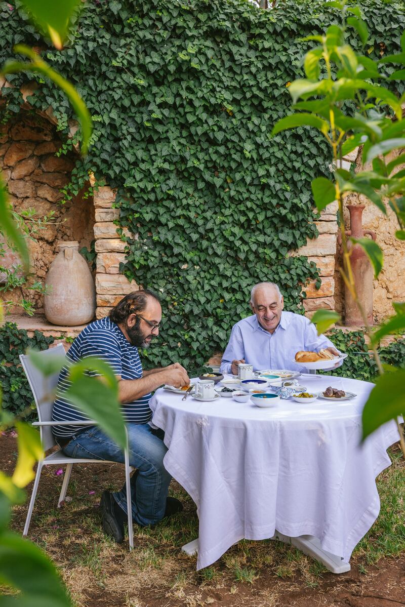 Fadi Kattan (L) eating breakfast with his father, Fuad