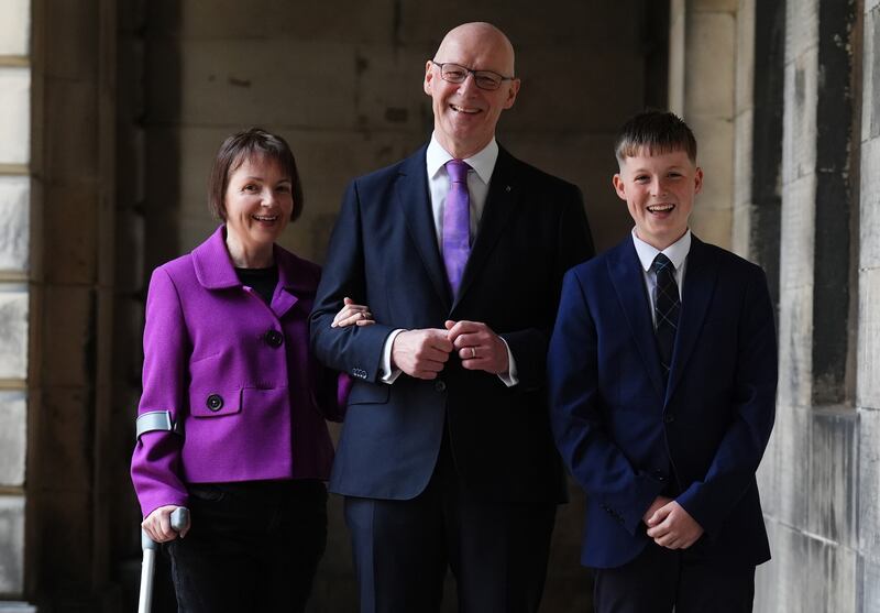 New Scottish First Minister John Swinney, with his wife Elizabeth Quigley and their son Matthew,13.