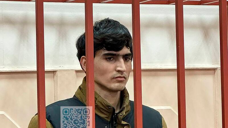 Dzhumokhon Kurbonov, a suspect in the Crocus City Hall shooting, stands in a cage in the Basmanny District Court in Moscow, Russia (Basmanny District Court press service via AP)