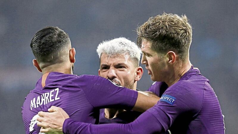 Manchester City forward Sergio Aguero is congratulated by team-mates after scoring his side&#39;s second goal against Lyon 