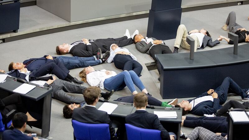 Young protesters lay on the floor in front of parliamentary speaker Wolfgang Schaeuble.