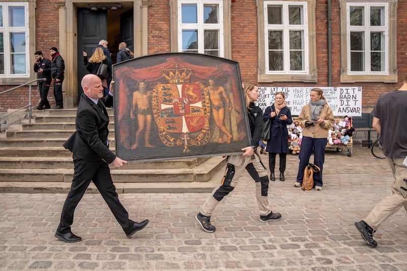 Historical paintings are carried out of the burning building as the Stock Exchange burns in Copenhagen (Ida Marie Odgaard/Ritzau Scanpix via AP)