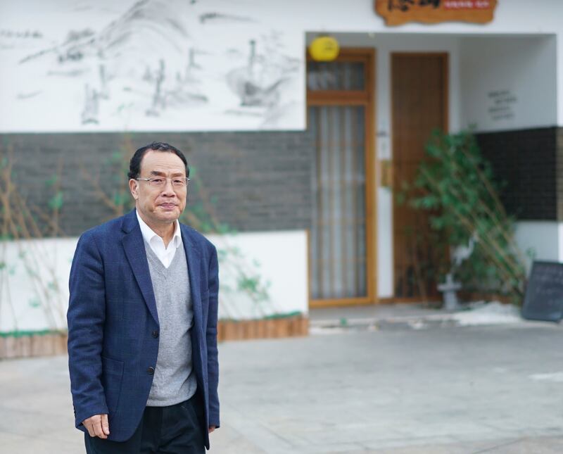 Zhang Yongzhen has said that he has been sitting outside his lab, despite pouring rain, since Sunday (AP Photo/Dake Kang)