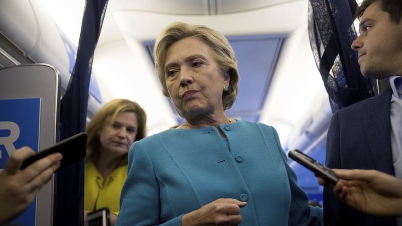 Democratic presidential candidate Hillary Clinton, accompanied by travelling press secretary Nick Merrill, right, and director of communications Jennifer Palmieri, left, takes a question from a member of the media aboard her campaign plane Picture by Andrew Harnik/AP 