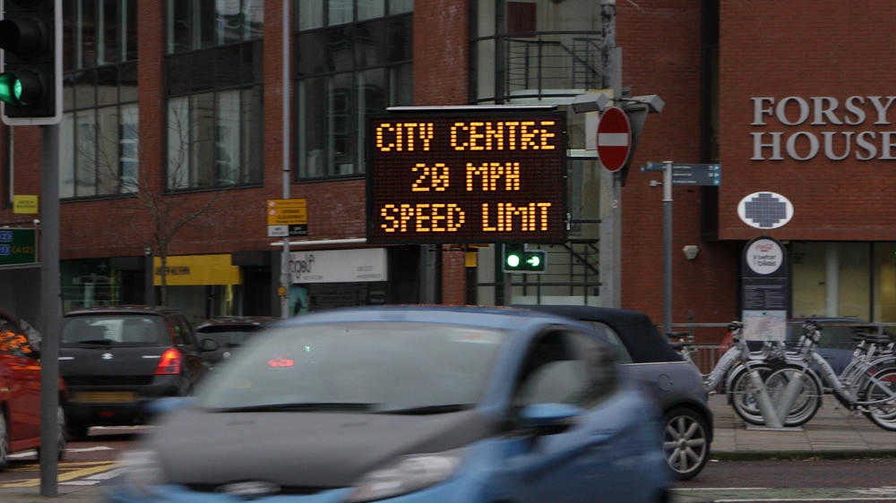 Signs in Belfast city centre warning of a new speed limit