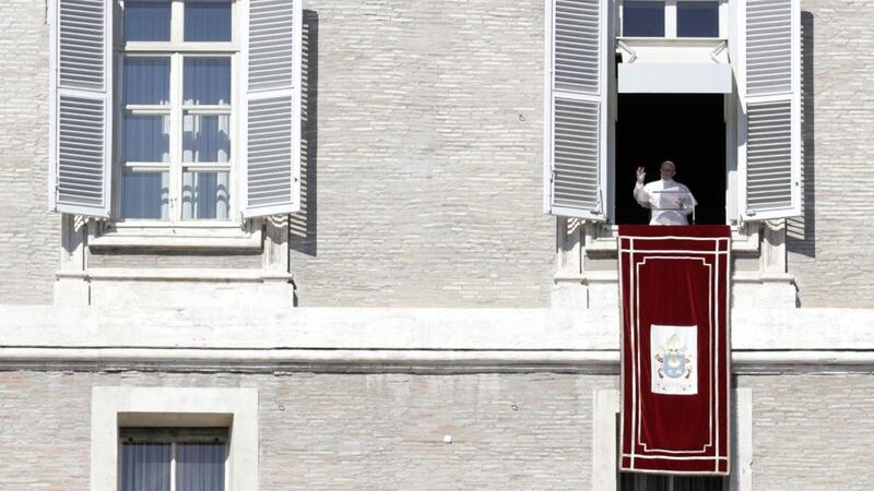 Pope Francis waves from his studio window during his Angelus prayer. Picture by AP Photo/Alessandra Tarantino 