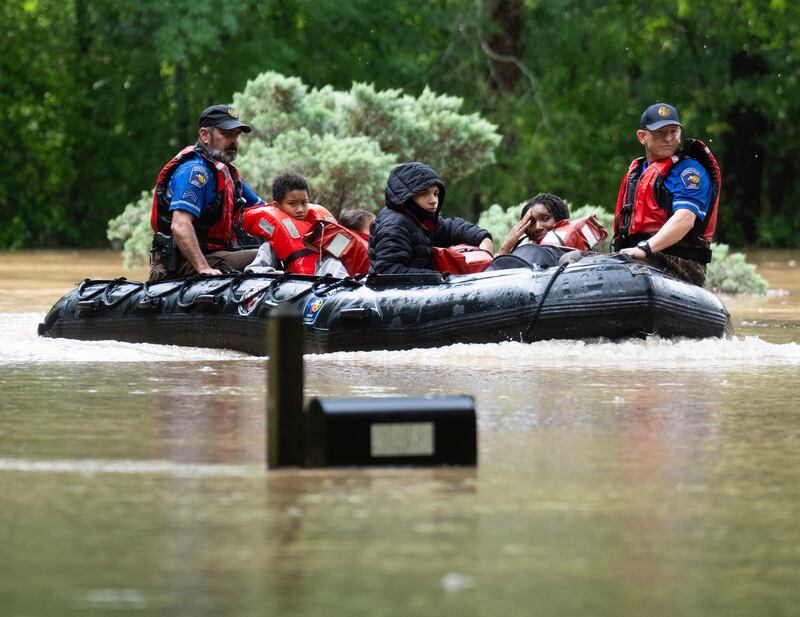People have been evacuated by boat from their homes (Houston Chronicle via AP)