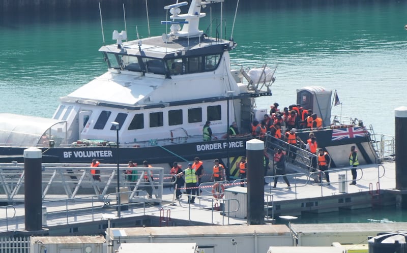 A group of people thought to be migrants are brought in to the Border Security Command compound in Dover, Kent