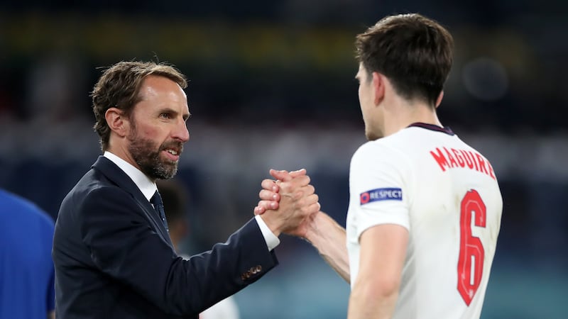 England manager Gareth Southgate shakes hands with Harry Maguire.