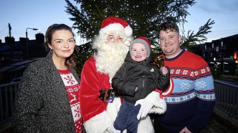 Daithi Mac Gabhann with his parents Mairtin Mac Gabhann and Seph Ni Mheallain switching on the Christmas lights at the Culturlann in west Belfast. Picture by Mal McCann. 