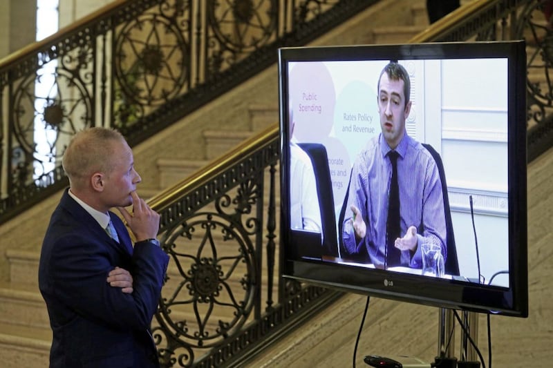 Jamie Bryson watches Sinn F&eacute;in MLA Daith&iacute; McKay on a screen before he appeared at the Stormont finance committee&#39;s Nama inquiry in September 2015. 