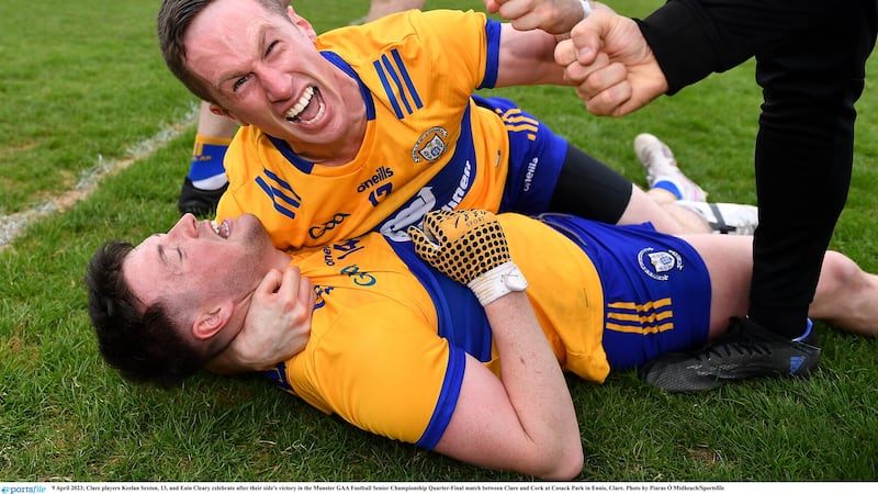 Clare players Eoin Cleary and Keelan Sexton (14) celebrate after their side's victory over Corkin the Munster SFC Picture by Piaras Ó Mídheach/Sportsfile
