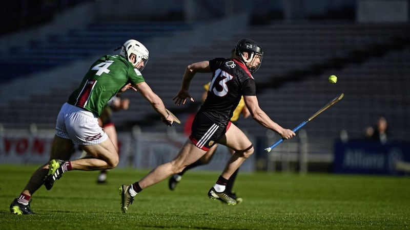 Down&#39;s Daithi Sands gets away from Conor Shaw during Saturday&#39;s NHL Division 2A final at Semple Stadium. Picture by Sportsfile 