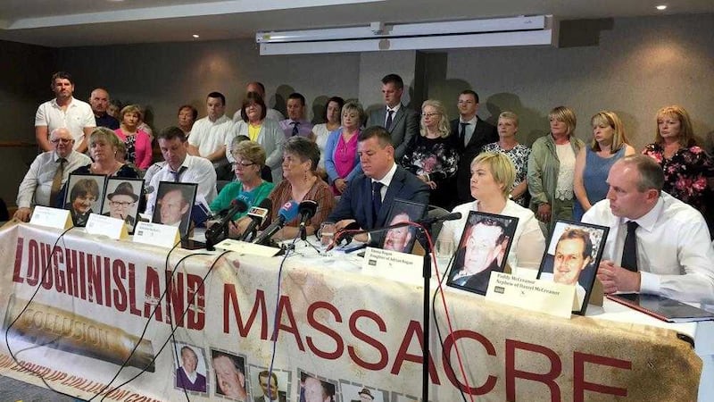 Solicitor Niall Murphy pictured with Loughinisland families 