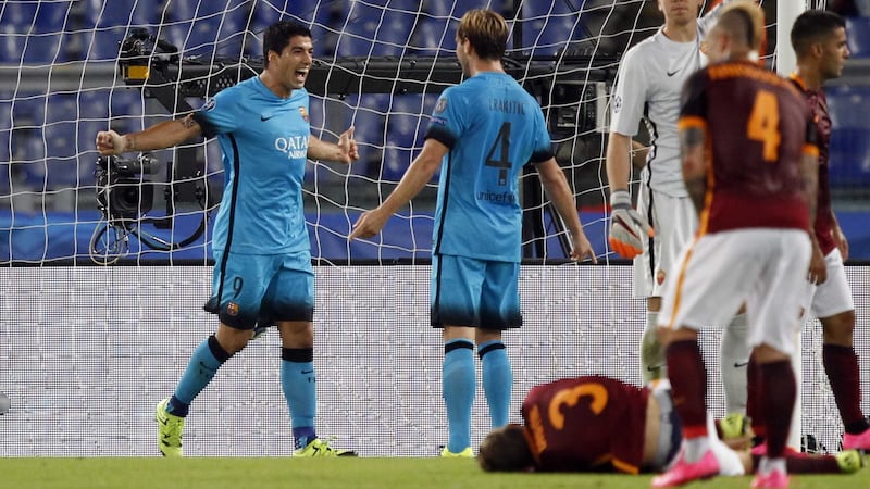 Barcelona's Luis Suarez celebrates with his team-mate Ivan Rakitic after scoring against Roma during Wednesday night's Champions League Group E clash<br />Picture: AP