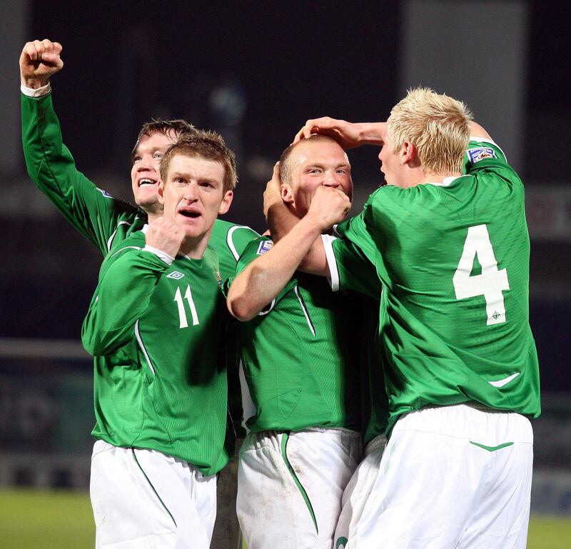 Northern Ireland's Warren Feeney celebrates with team mates including Steven Davis after scoring during the World Cup Qualifying match against Slovenia at Windsor Park in 2009