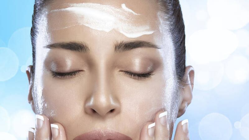 Beautiful spa woman applying a spa treatment. Perfect skin. Skincare concept. Nude makeup 