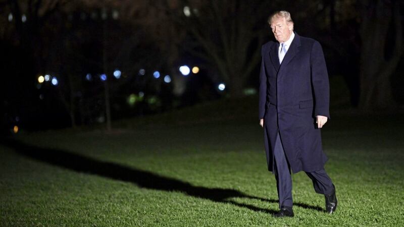 President Trump walks on the South Lawn of the White House in Washington on Wednesday after returning via Marine One. Trump was returning from a two-day trip to California and Missouri PICTURE: Susan Walsh/AP 
