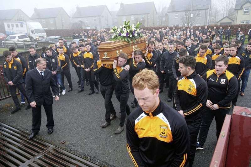 Pomeroy Plunketts GAA members gather around the graveside of Christopher Colhoun. Picture by Mal McCann 