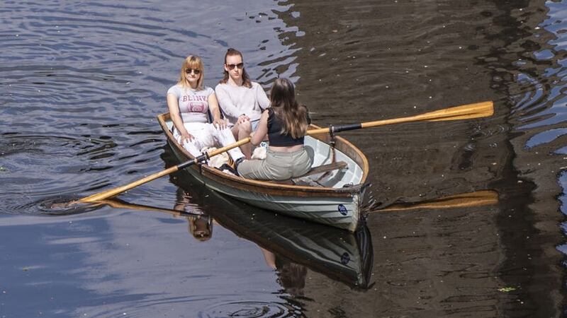 People enjoy the hot weather in a rowing boat on River Nidd in Knaresborough, North Yorkshire (Danny Lawson/PA)