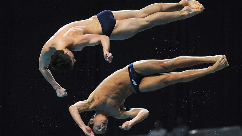 England's Max Brick and Tom Daley on their way to a gold medal in the Men's 10m Synchro Platform during the 2010 Commonwealth Games in New Dehli