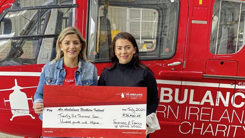 Willis Vogel&#39;s sisters, Christa (left) and Rebecca, present the Northern Ireland Air Ambulance team with a cheque for &pound;26,700 raised in memory of the 21-year-old 