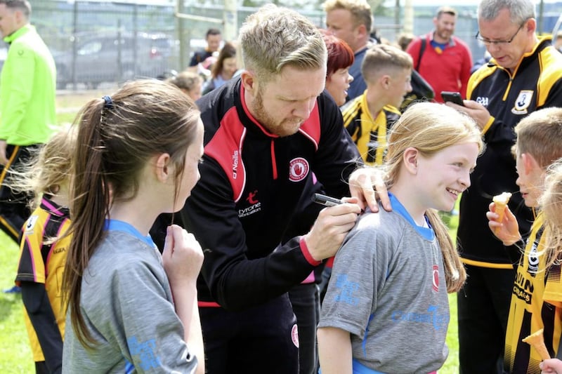 Tyrone player Frank Burns signs young fans&#39; shirts at a GAA summer camp in Pomeroy 