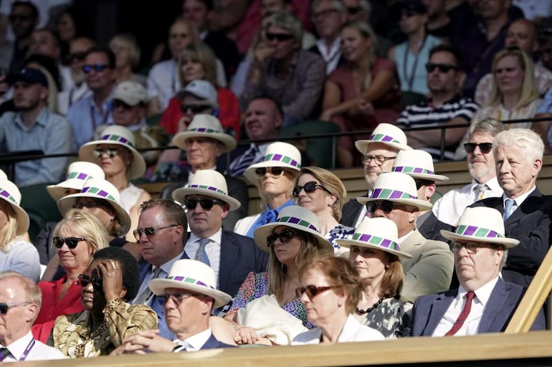 Spectators in the Royal Box wear sun hats on day seven of the 2023 Wimbledon Championships 