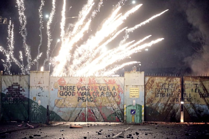 A firework explodes during clashes at the Lanark Way peace wall in west Belfast on April 7. Picture by AP Photo/Peter Morrison 