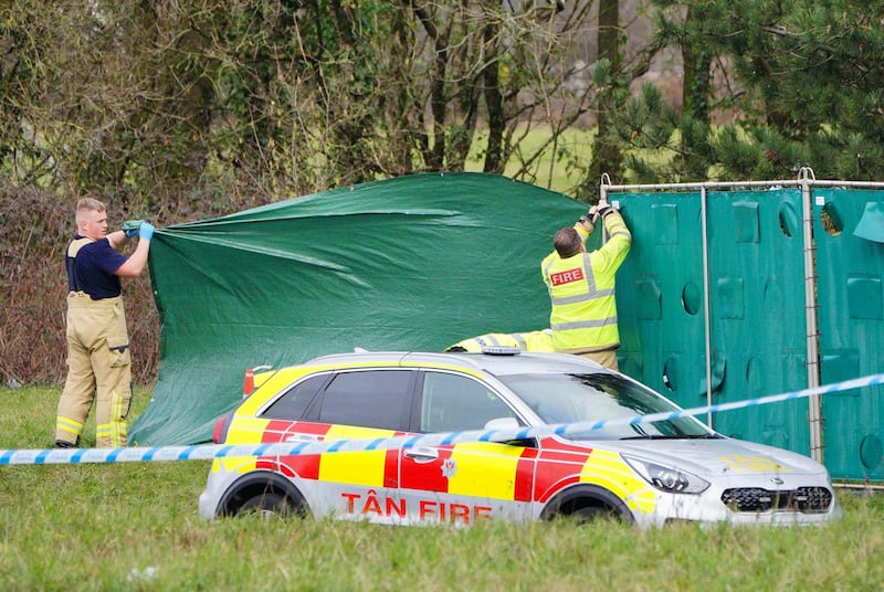 Firefighters erect screens at the scene of the crash in the St Mellons area (Ben Birchall/PA)