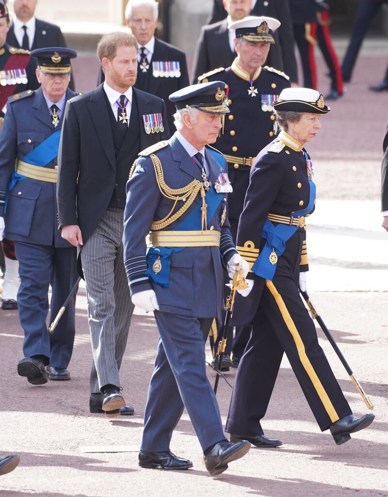 King Charles III, the Princess Royal, followed by the Duke of Sussex and Vice Admiral Sir Tim Laurence walking behind he coffin of Queen Elizabeth II during the ceremonial procession from Buckingham Palace to Westminster Hall,