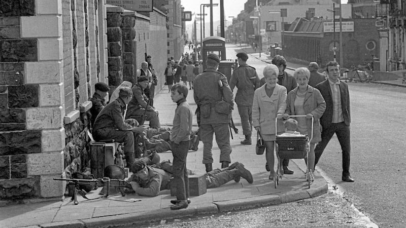 File photo dated 17/08/1969 of women on Crumlin Road, Belfast, pushing a pram around the legs of a soldier laying with his gun trained on Hooker Street. The start of the Troubles in the late 1960s is thought to have fuelled the interest of a Metropolitan Police unit in groups campaigning on Irish issues in England and Wales. Picture from Press Association 