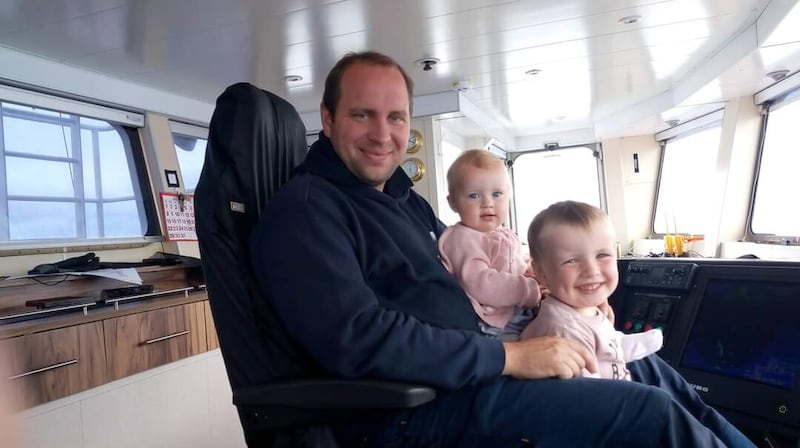 Former Rathlin ferry skipper Fergus McFaul with his children Dáire and Lily
