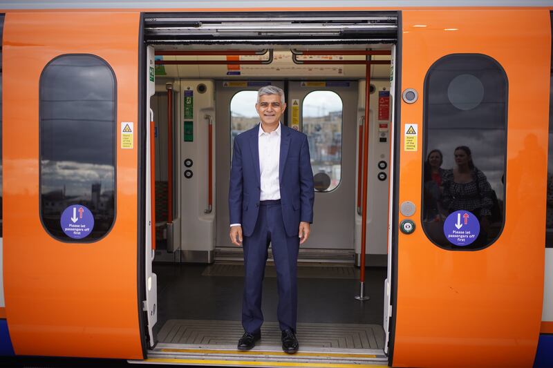Mayor of London Sadiq Khan poses in a carriage of a London Overground train