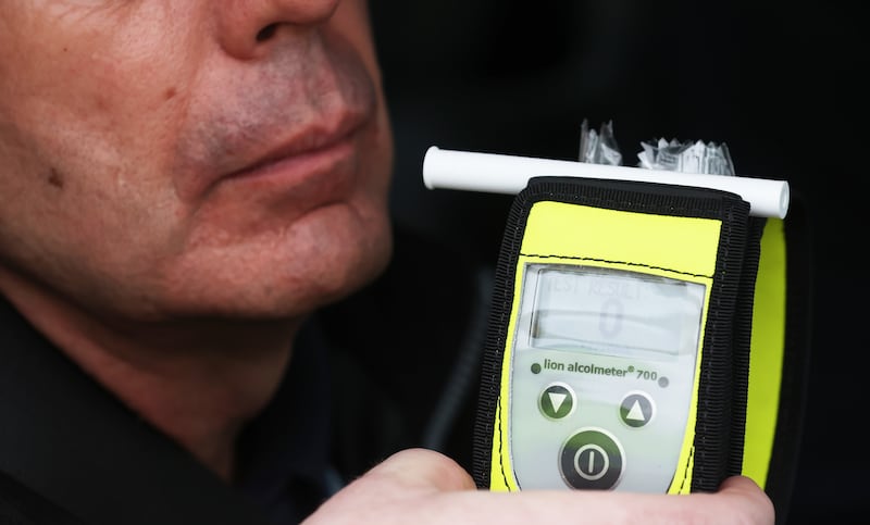 A driver blows into a breathalyser at the launch of the 2022/23 police winter anti-drink/drug drive operation on Sydenham Road in Belfast. Picture date: Thursday December 1, 2022.