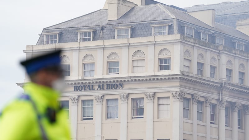 A police community support officer wears goggles and a face mask at the scene in Brighton after a fire at the Royal Albion Hotel (Gareth Fuller/PA)